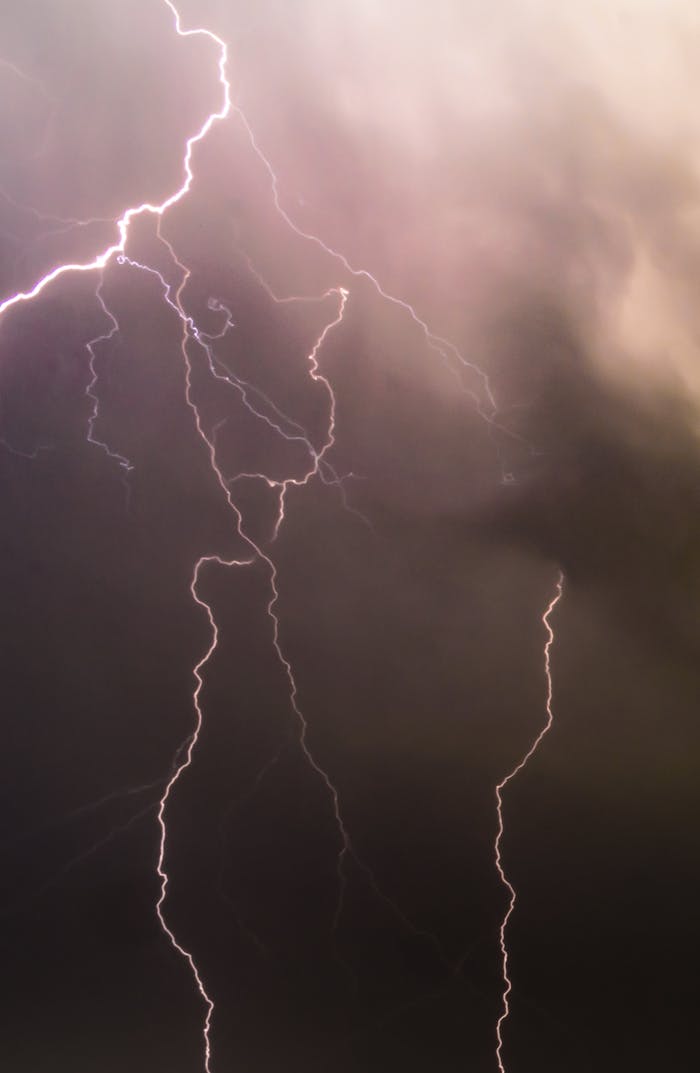 Captivating long exposure of lightning bolts during a nighttime thunderstorm showcasing nature's power.